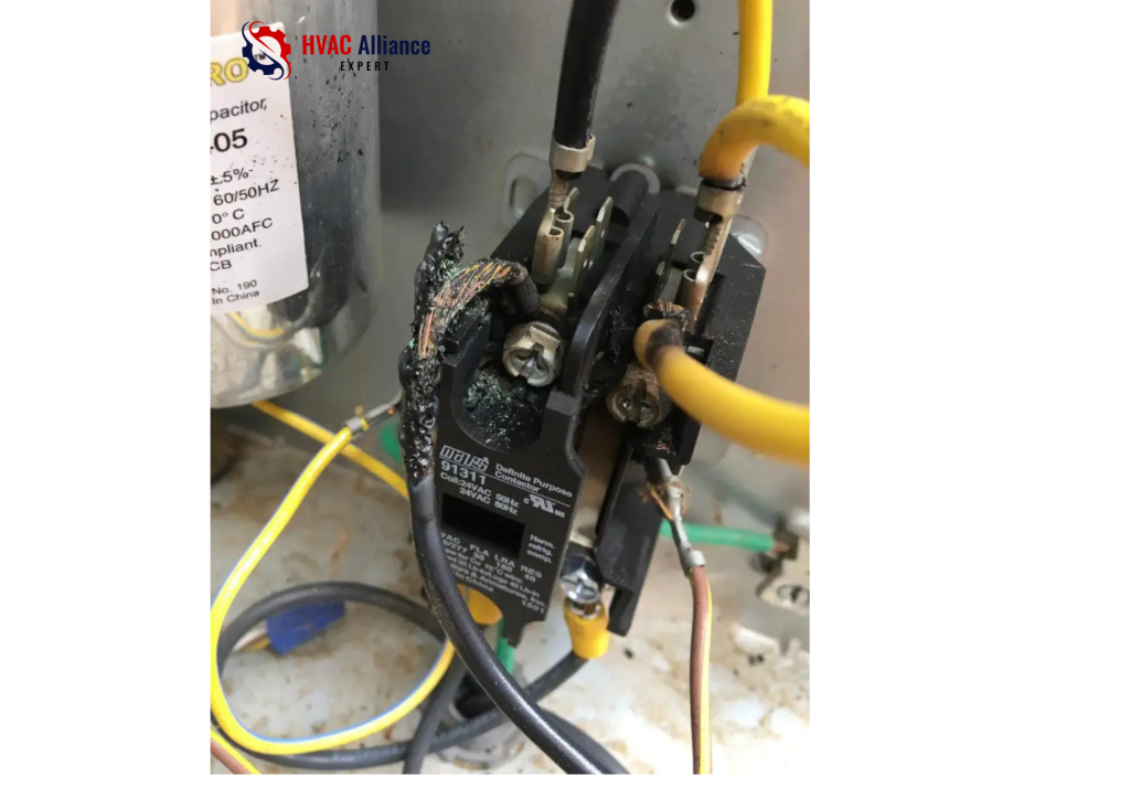 Burned and damaged AC contactor relay in outdoor unit electrical compartment causing hissing buzzing sound from air conditioner