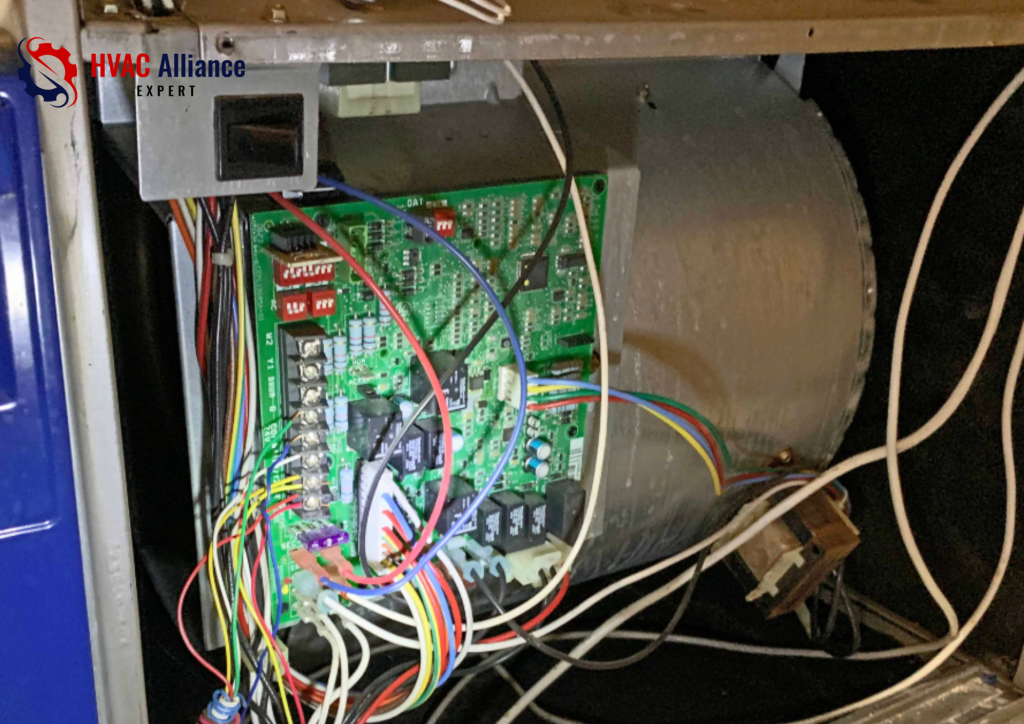 Close-up of a modern furnace control board with colorful low-voltage and high-voltage wiring, the "brain" of the HVAC system that manages the heating cycle.