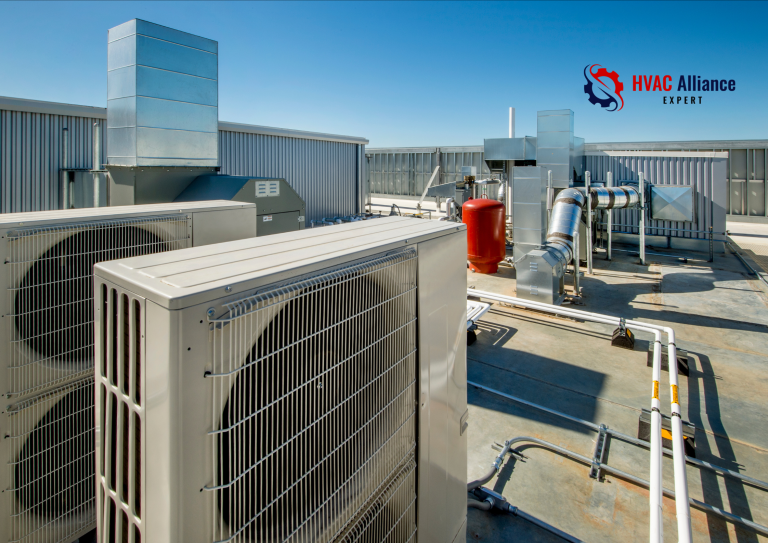 A wide-angle view of a commercial rooftop HVAC installation featuring multiple large condenser units, ductwork, and piping under a clear blue sky, with the HVAC Alliance Expert logo.